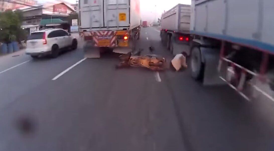 Lucky-Biker-Somehow- Not-Crushed-By-Two-Trucks
